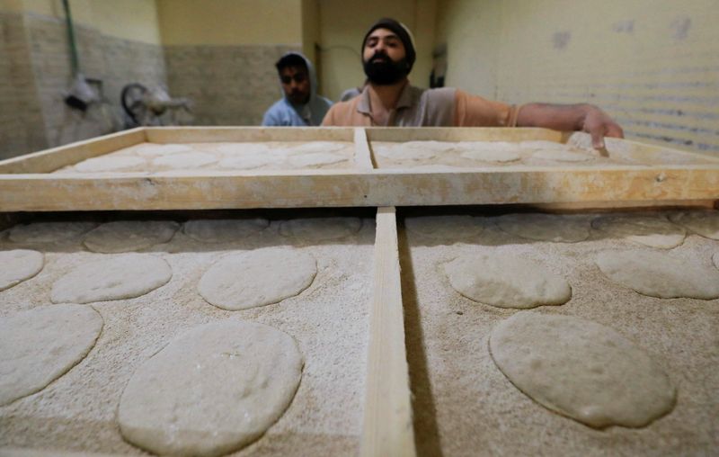FILE PHOTO: Egyptian workers making bread at a bakery in