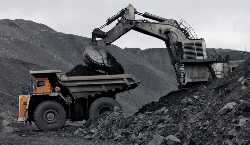FILE PHOTO: A machine loads a truck with coal at
