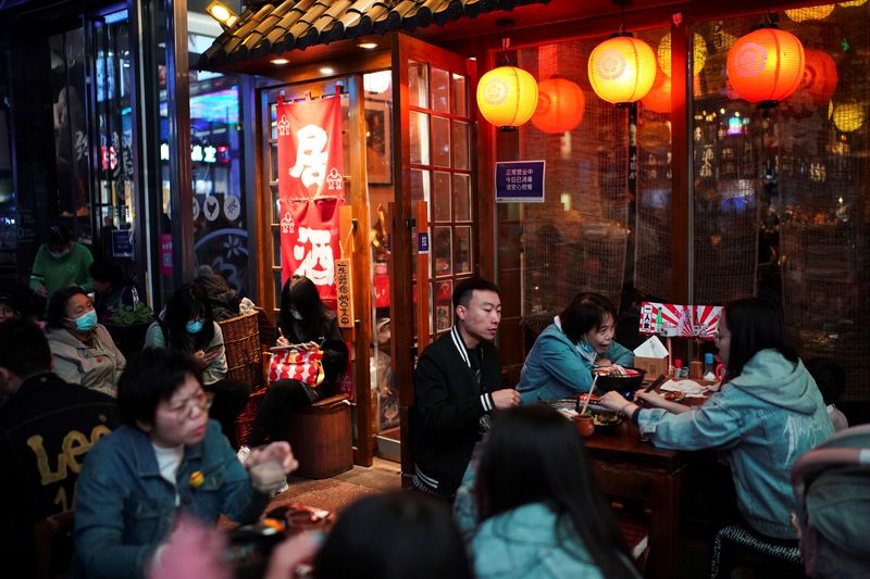 People dine at a restaurant in Beijing