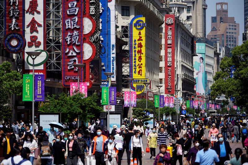 People walk along Nanjing Pedestrian Road during the Labour Day