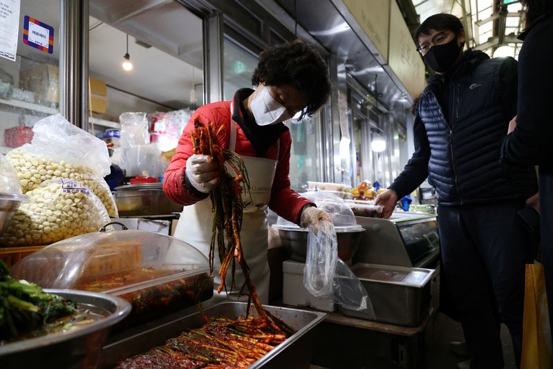 Choi Sun-hwa sells a traditional Korean side dish kimchi at