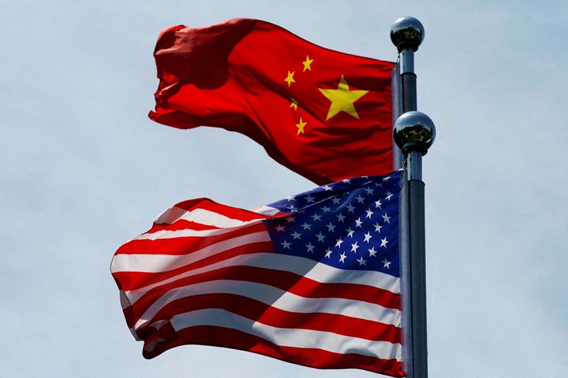 FILE PHOTO: Chinese and U.S. flags flutter near The Bund