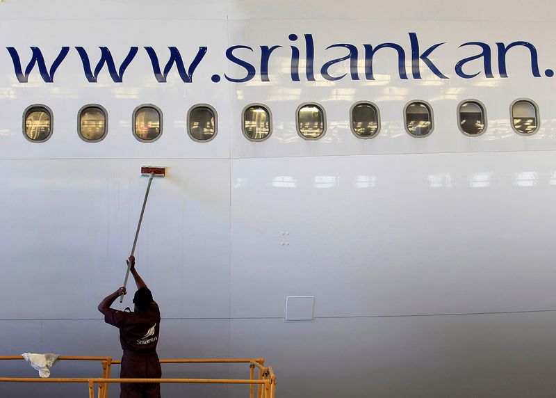 An engineer cleans an Airbus 340 at the Sri Lankan