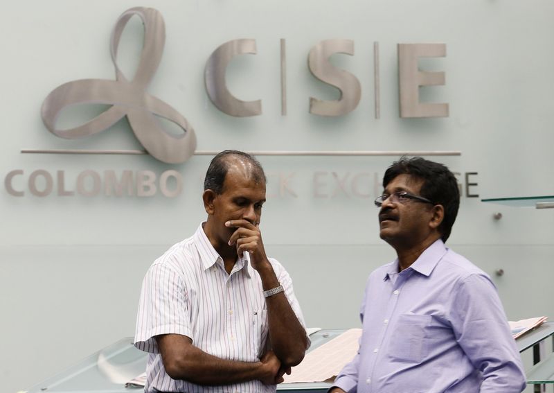 Investors react at the Colombo Stock Exchange in Sri Lanka