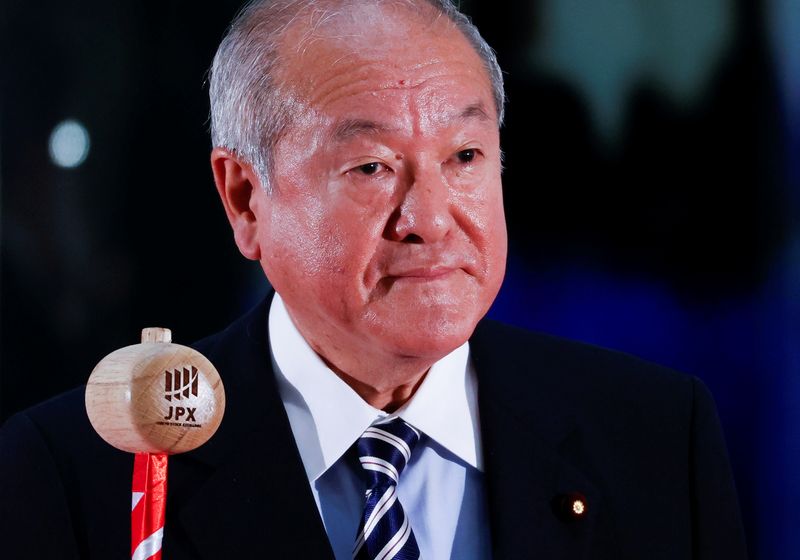 Japan’s Finance Minister Shunichi Suzuki prepares to ring a bell