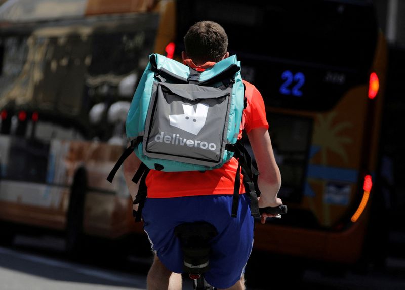 FILE PHOTO: A food delivery cyclist carries a Deliveroo bag