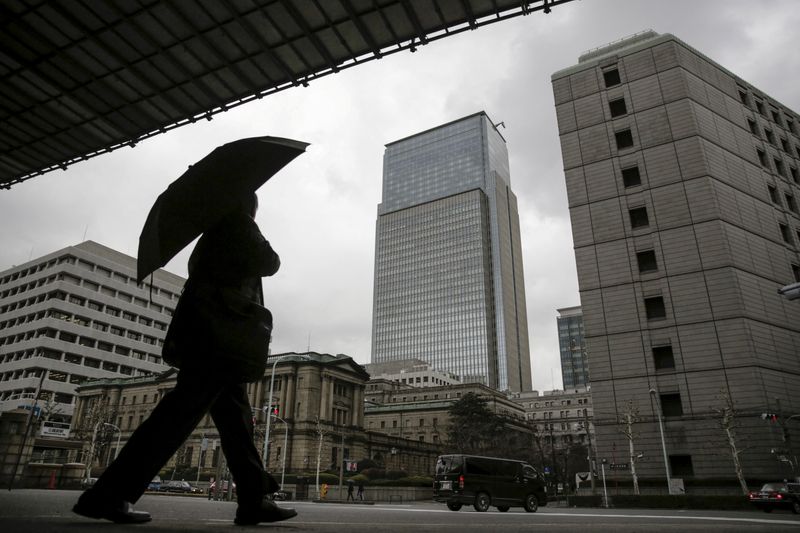 FILE PHOTO:  A businessman walks near the Bank of