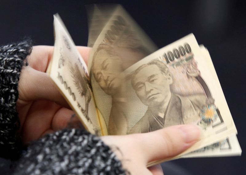 A woman counts Japanese 10,000 yen notes in Tokyo, in