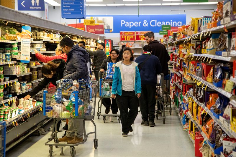 FILE PHOTO: People gather supplies at a grocery store in