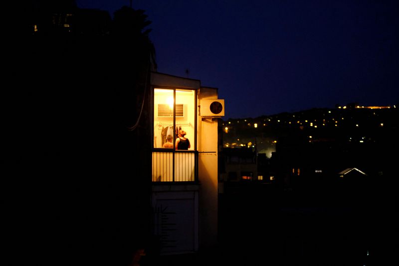 FILE PHOTO: Illuminated house is pictured near the air conditioning