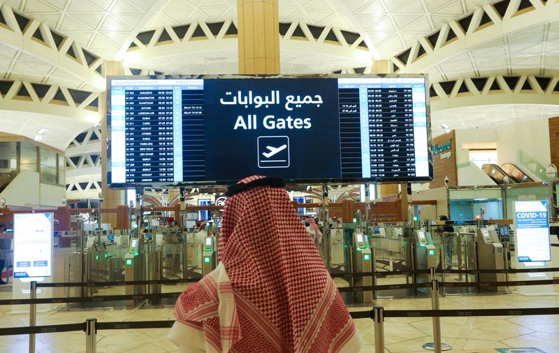 FILE PHOTO: A Saudi man checks the flight timings at