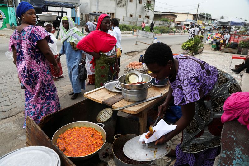 A woman sell plantains fried in crude palm oil, on