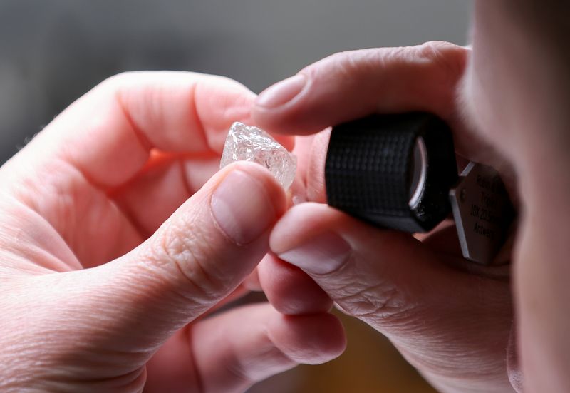 FILE PHOTO: An employee holds a rough diamond at the