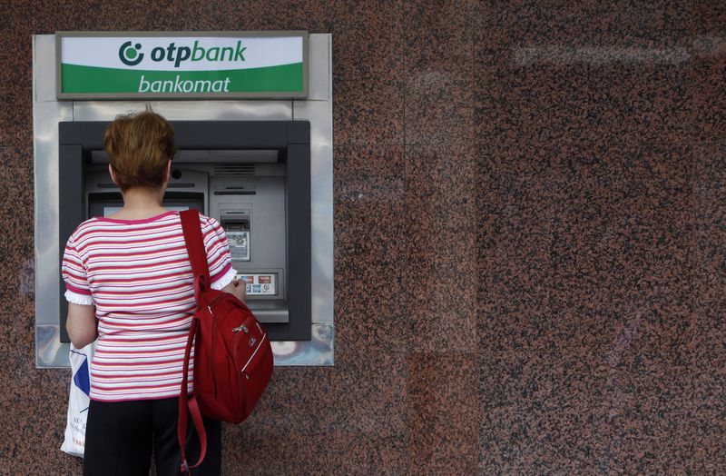 A woman withdraws money from an ATM at an OTP