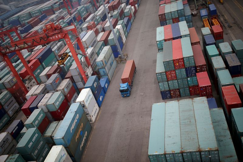 FILE PHOTO: A truck drives between shipping containers at a
