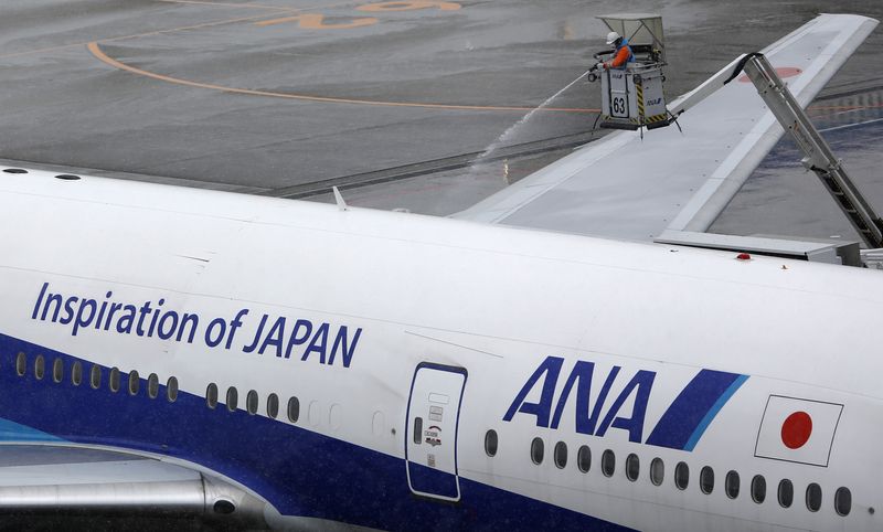 FILE PHOTO: A man works near an All Nippon Airways’