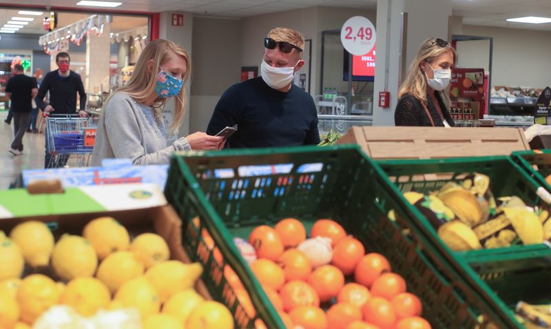 FILE PHOTO: People shop in a supermarket in Bad Honnef