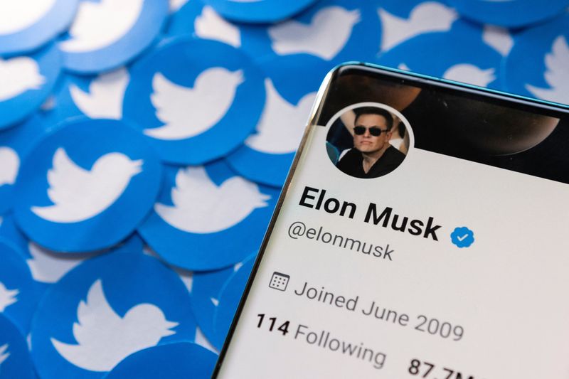 Illustration shows Elon Musk’s Twitter profile on smartphone and printed
