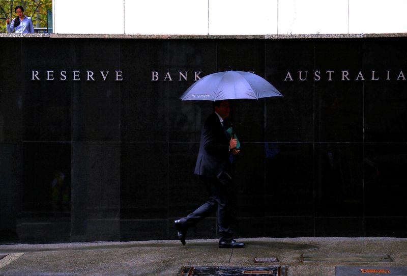 FILE PHOTO: Pedestrians walk past the Reserve Bank of Australia