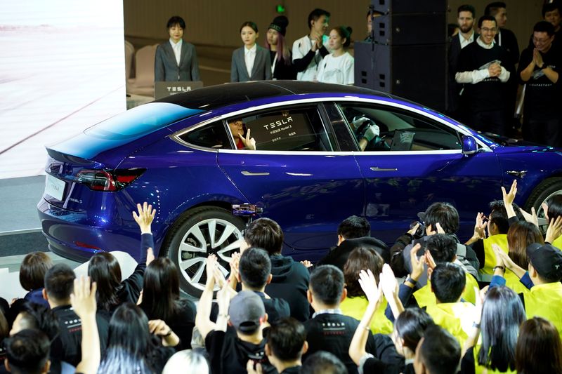Tesla China-made Model 3 vehicle owner sits inside a car