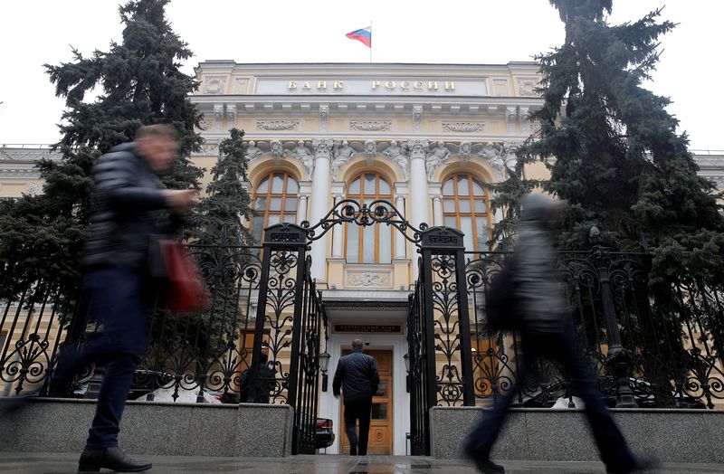FILE PHOTO: People walk past the headquarters of Russia’s Central