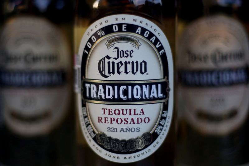 Bottles of Jose Cuervo Tequila rest on a shelf in