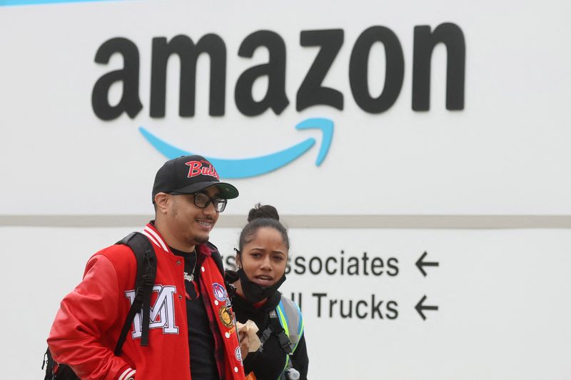 Amazon workers walk outside Amazon’s LDJ5 sortation center in Staten