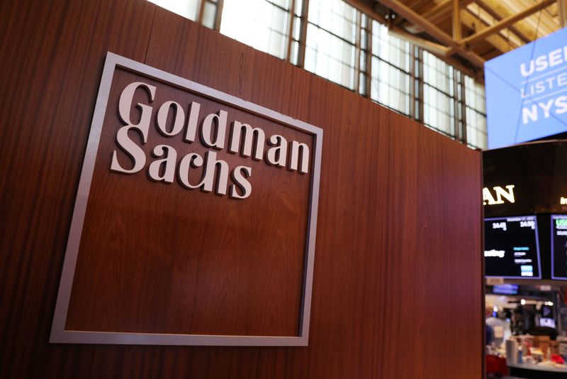 The logo for Goldman Sachs is seen on the trading