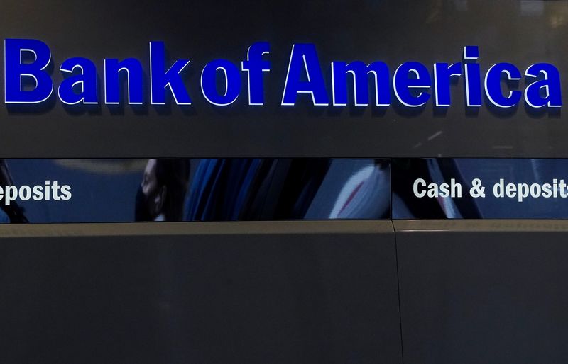 Person walks past a Bank of America sign in New