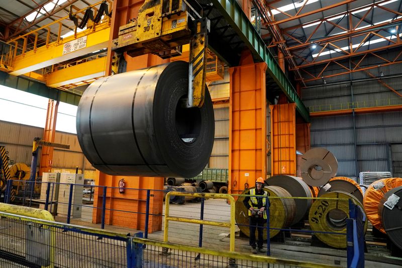 FILE PHOTO: A steel roll is moved by the crane