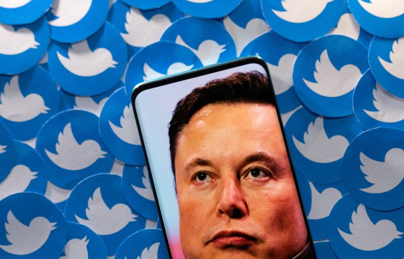 Illustration shows Elon Musk image on smartphone and printed Twitter