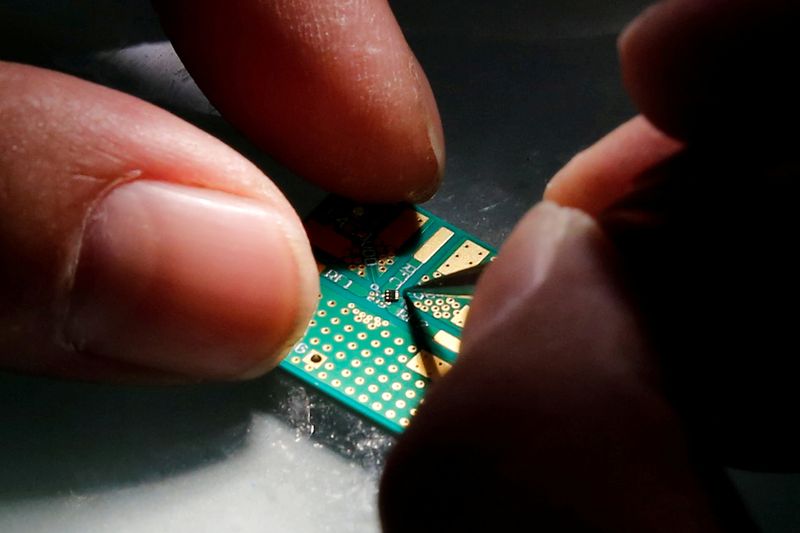 FILE PHOTO: A researcher plants a semiconductor on an interface