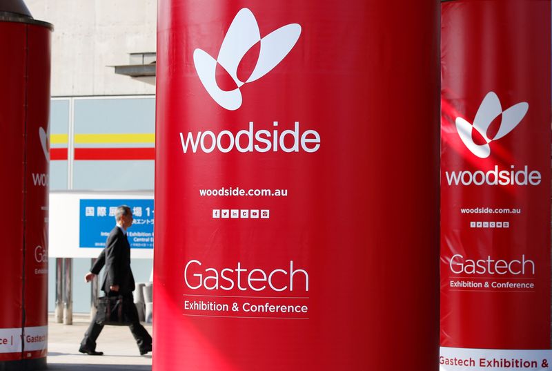 Logos of Woodside Petroleum are seen at Gastech, the world’s