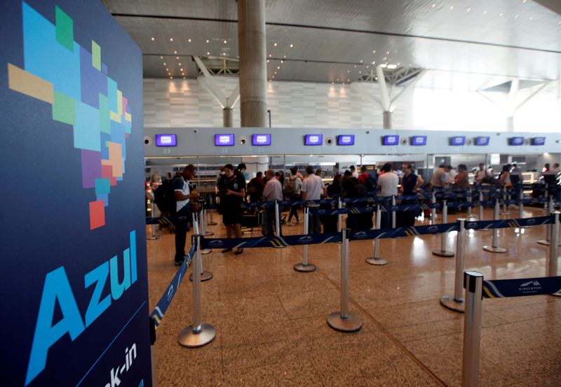 FILE PHOTO: People queue at Brazil’s airline Azul check-in at