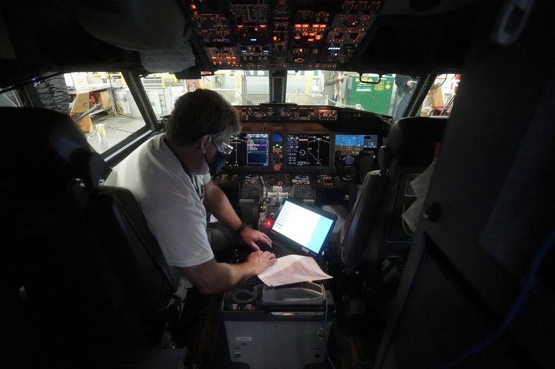 FILE PHOTO: A worker loads new software into the Boeing