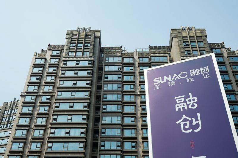 Advertisement of Sunac China Holdings is seen at a residential