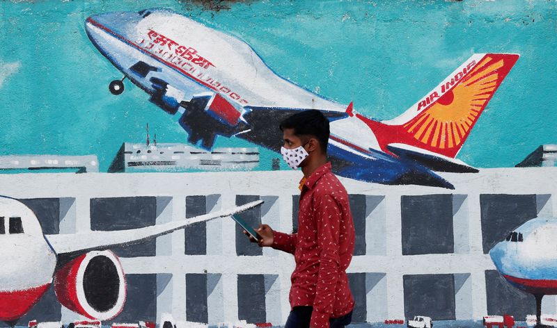 FILE PHOTO: A man walks past a mural of Air