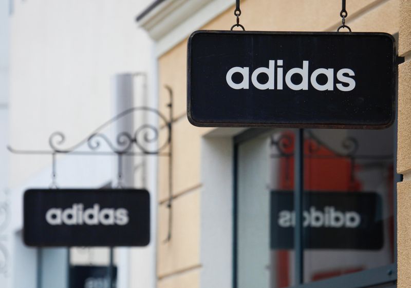 Boards with Adidas store logo are seen on a shopping