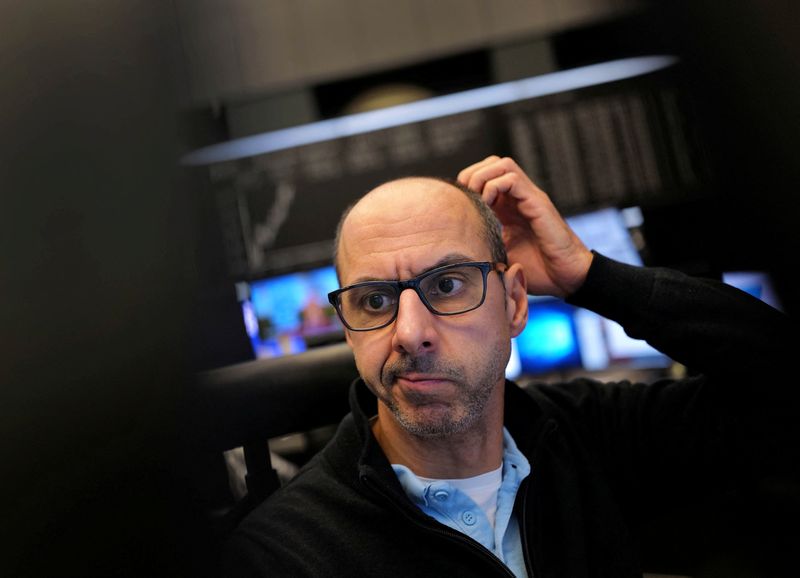 FILE PHOTO: A stock trader looks at his monitors at