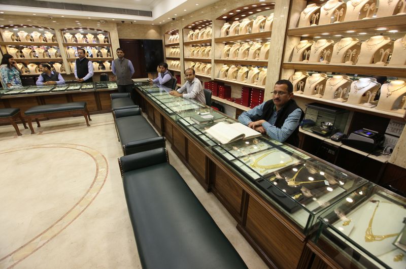 Sales persons wait for customers at a gold jewelry showroom