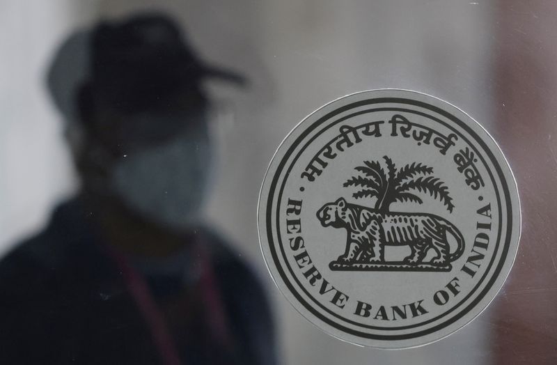 A man walks behind the Reserve Bank of India (RBI)