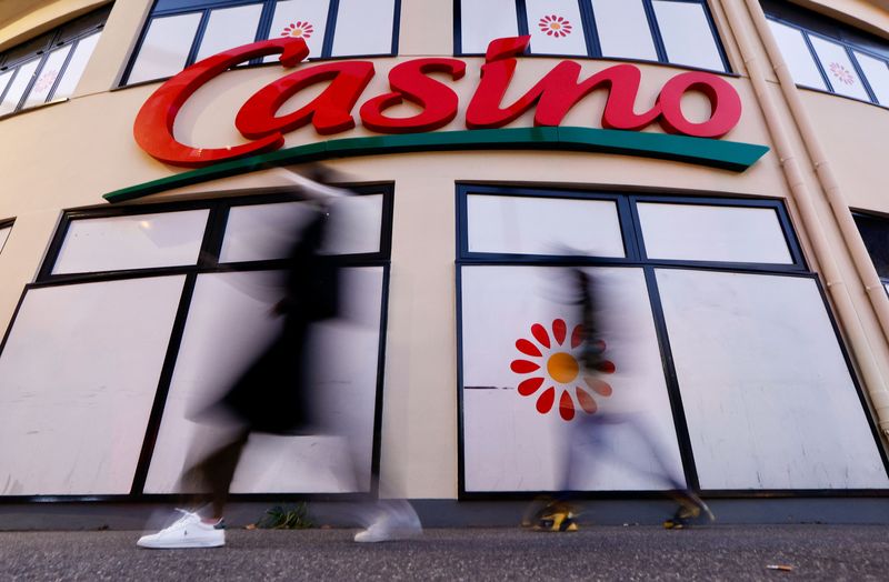 People walk past a Casino supermarket in Nice