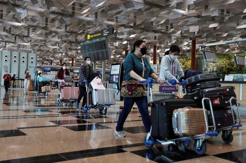 Travellers are seen at Changi Airport in Singapore