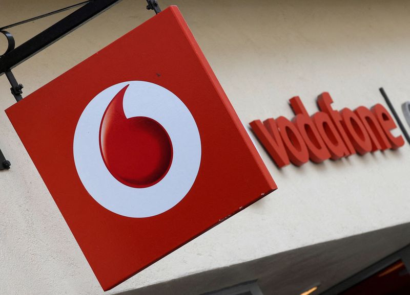 FILE PHOTO: Branding hangs outside a Vodafone shop in Oxford