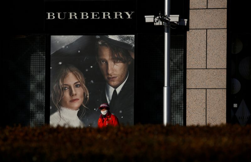 FILE PHOTO: A woman walks past a Burberry boutique in