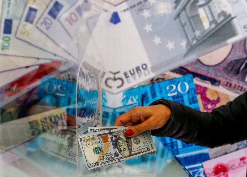 FILE PHOTO: A money changer sells U.S. dollar bills in