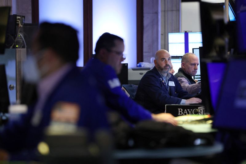 FILE PHOTO – Traders work on the trading floor at
