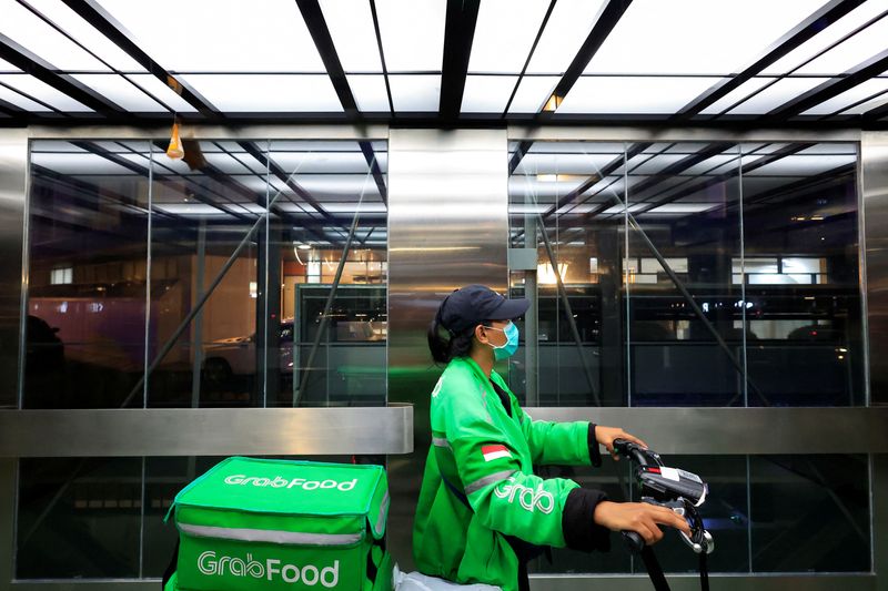 FILE PHOTO: Driver working for the ridesharing company Grab delivers