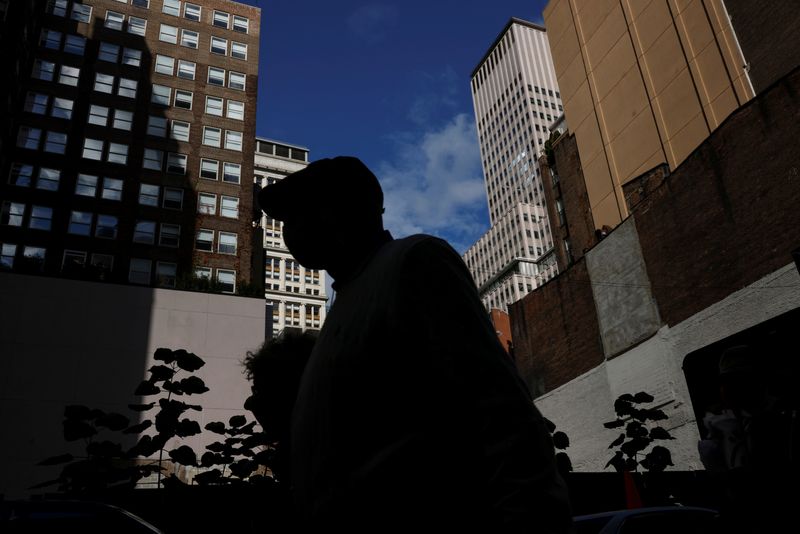FILE PHOTO: A man is seen silhouetted wearing a protective