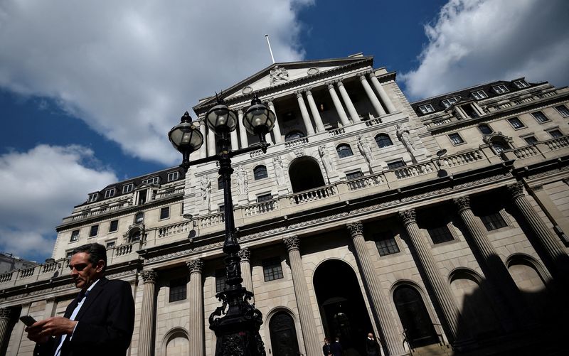FILE PHOTO: A man stands outside the Bank of England